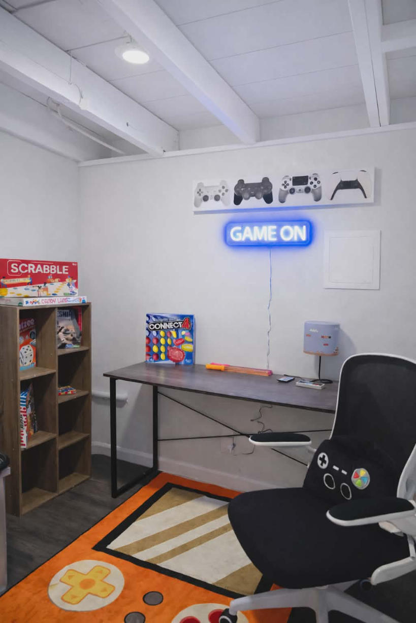 Find a desk in the game room for you to set up your favorite PC games, complete with a Nintendo style lamp and a shelf with plenty of board and card games to play!