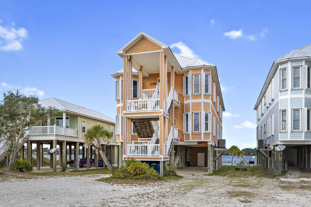 Front view of the elevated coastal home with covered porches