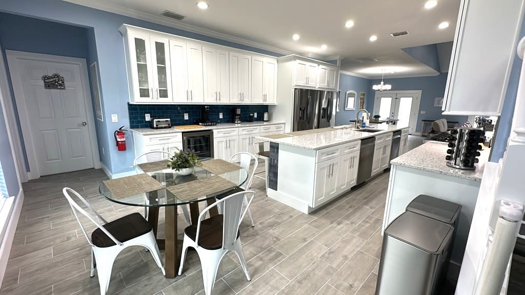 Chef Kitchen with huge island, range, two fridges, drinks fridge, and more. 