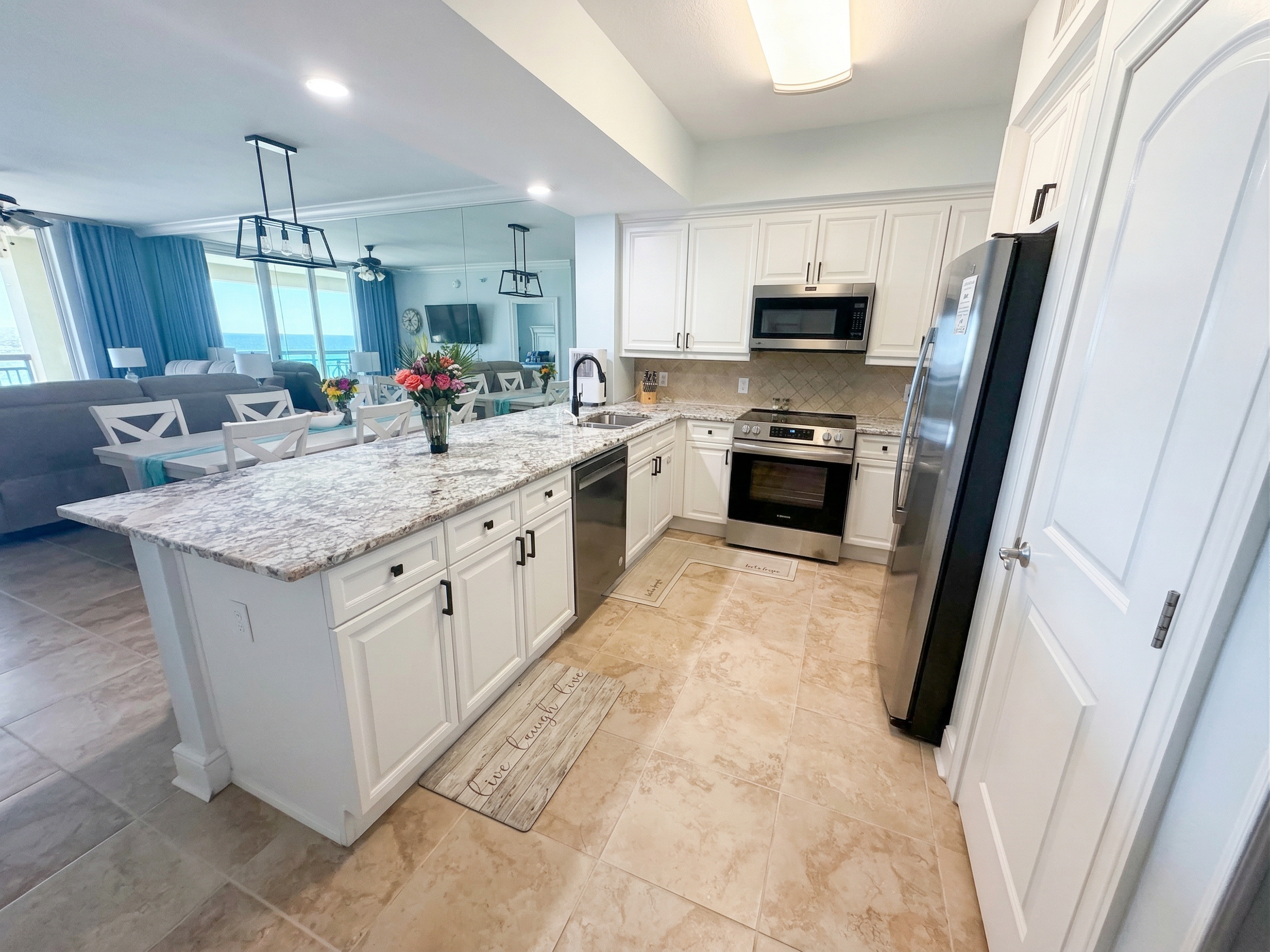 Spacious kitchen with granite countertops, stainless appliances, and bar seating—perfect for coffee mornings or family meals together.