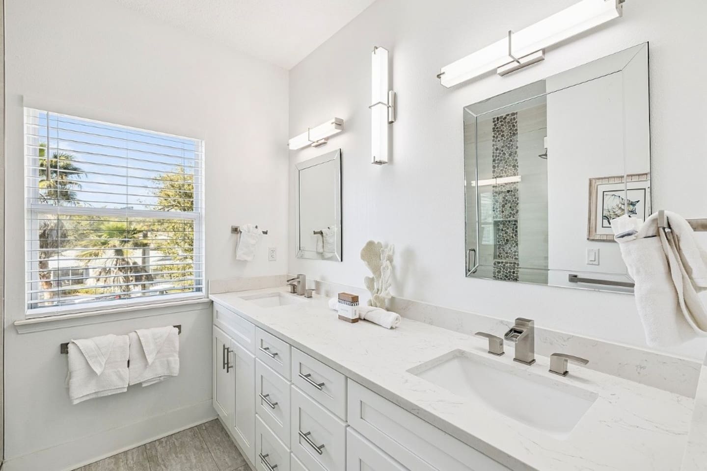 Bright and private en-suite bathroom equipped with contemporary fixtures and an expansive vanity counter