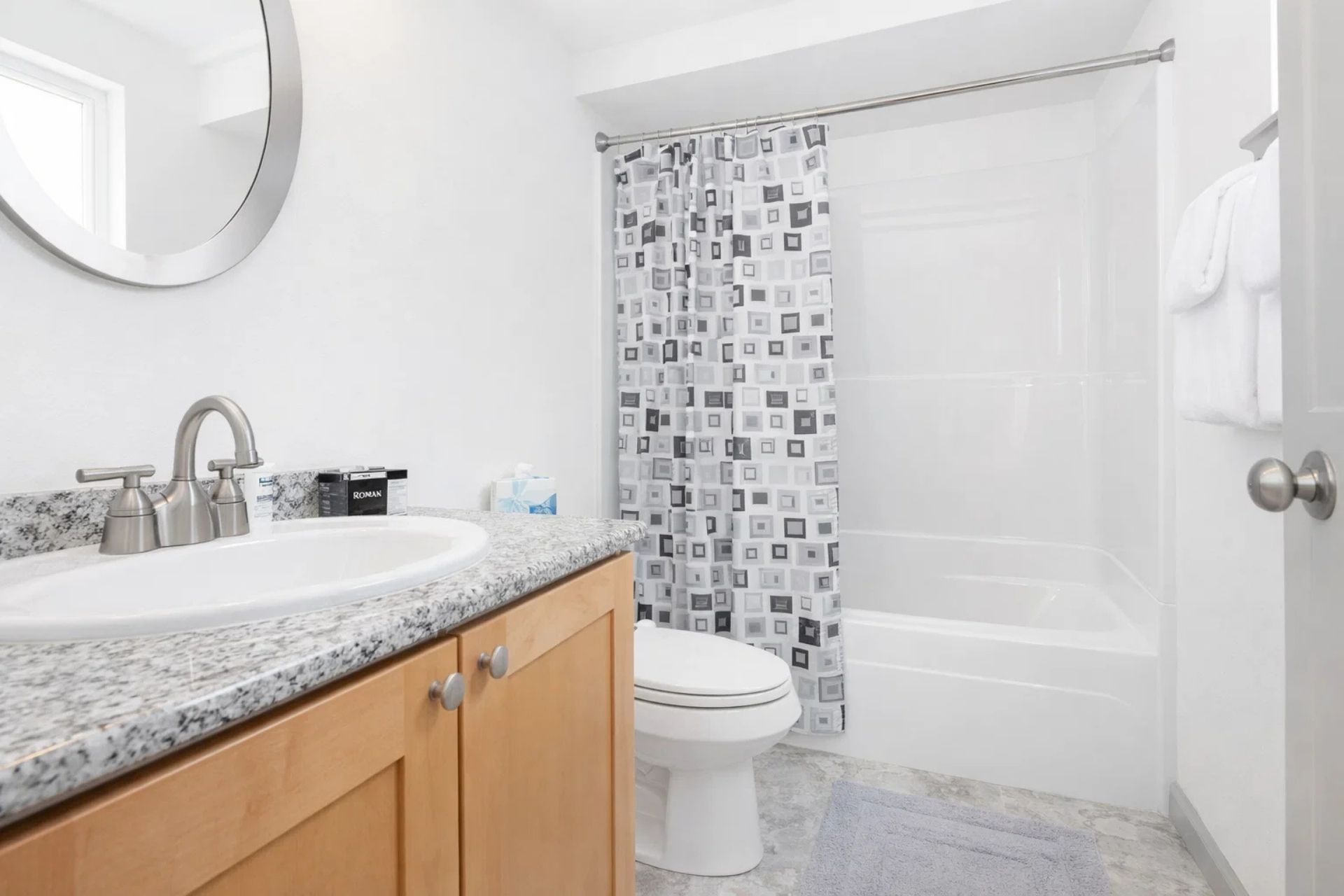 Bathroom Bliss: Modern granite countertops and fresh amenities await your seaside retreat!