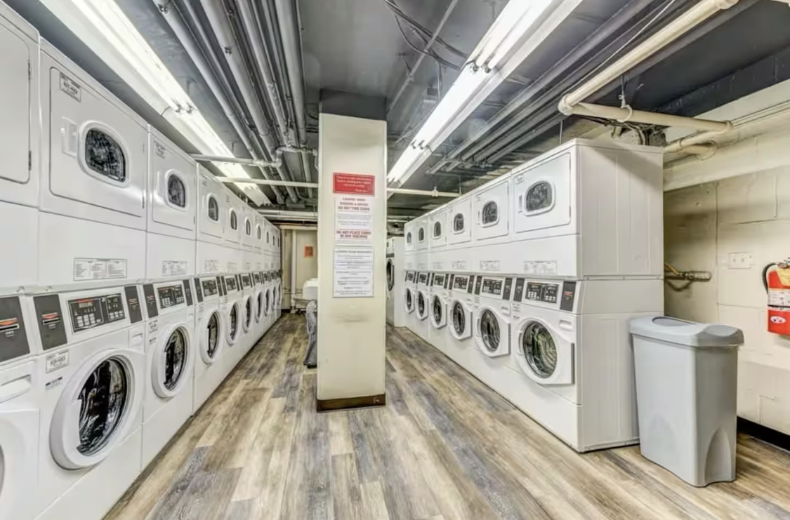 The condo does not have an in-unit washer and dryer. However, a shared laundry room is conveniently located on Level B of the building and is available for residents and guests to use for a small fee. The laundry machines accept card payment.