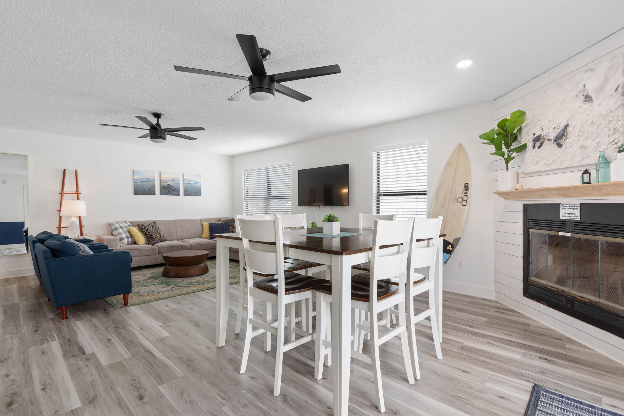 This is where beach days begin and end—breakfast around the table, cards after dinner, and everyone drifting from the couch to the fireplace with one more story to tell. Bright, open, and easy, it is a space made for family memories to settle in.