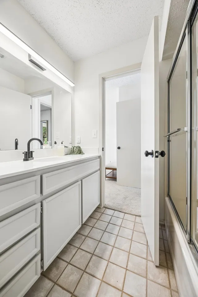 Full bathroom with a bright vanity area.
