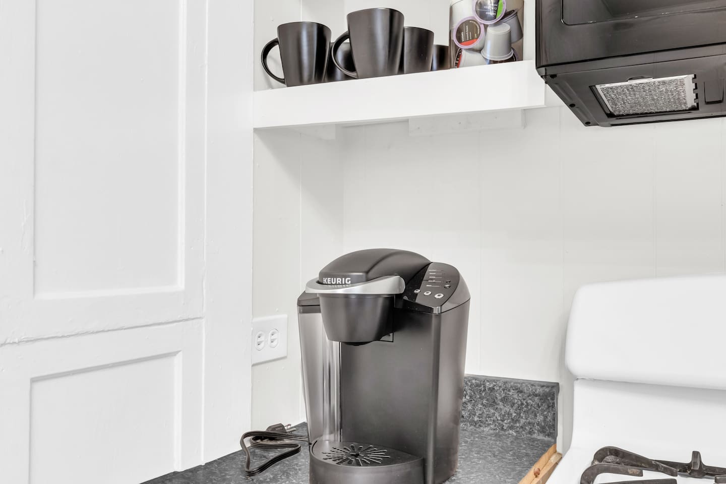 Coffee station with Keurig and mugs for your morning brew.