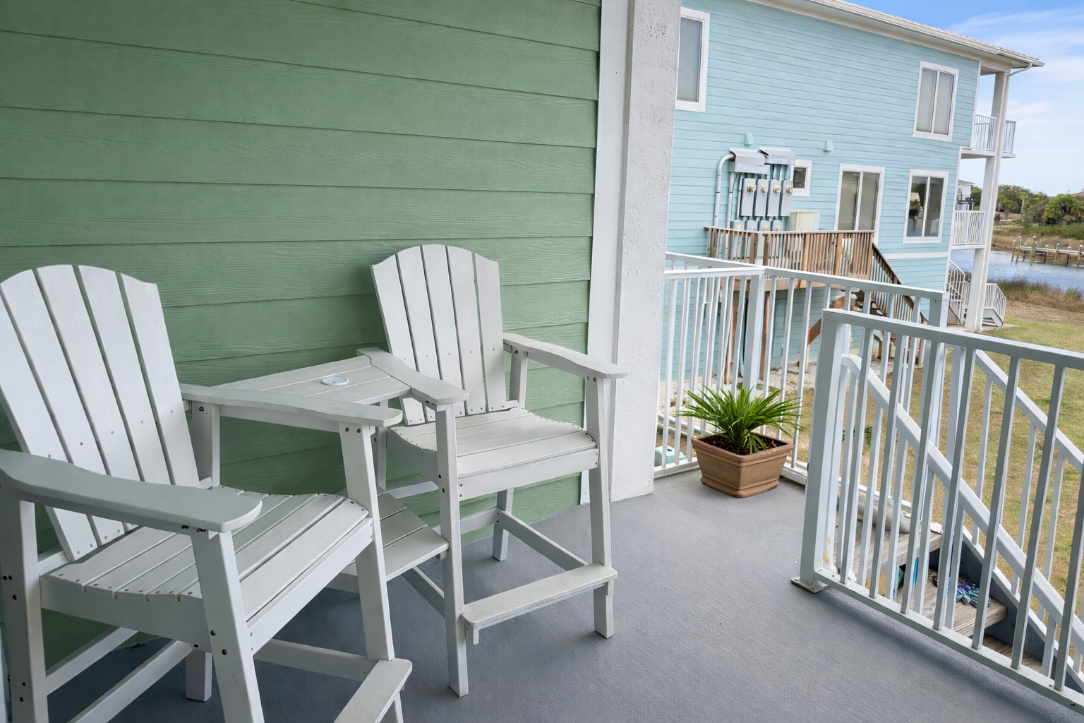 Private waterfront balcony with outdoor seating