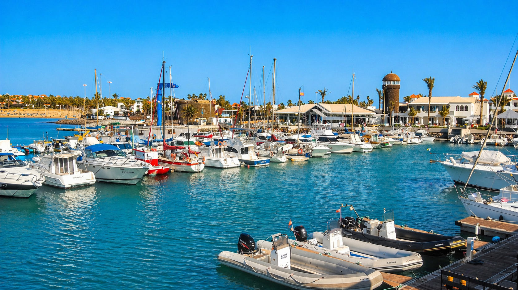 Enjoy the lively marina of Caleta de Fuste, a perfect place for strolls, dining, and charming evenings by the sea.