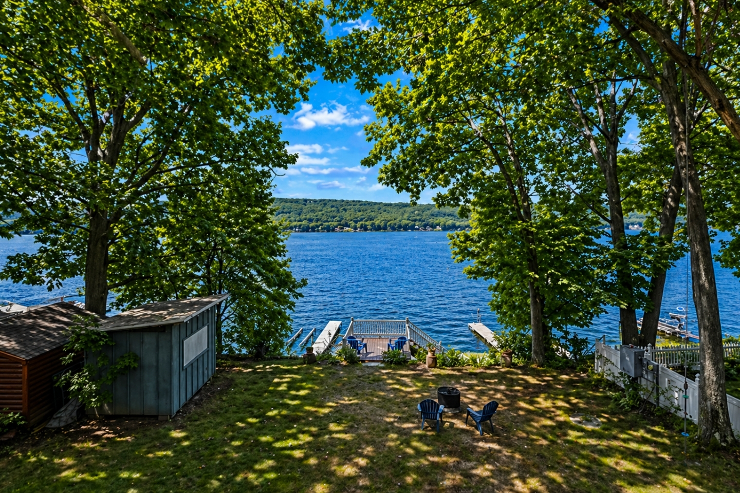 Peaceful lakefront view at Willow Beach, Honeoye, NY—perfect for enjoying a cozy fire by the water with stunning nature all around. 