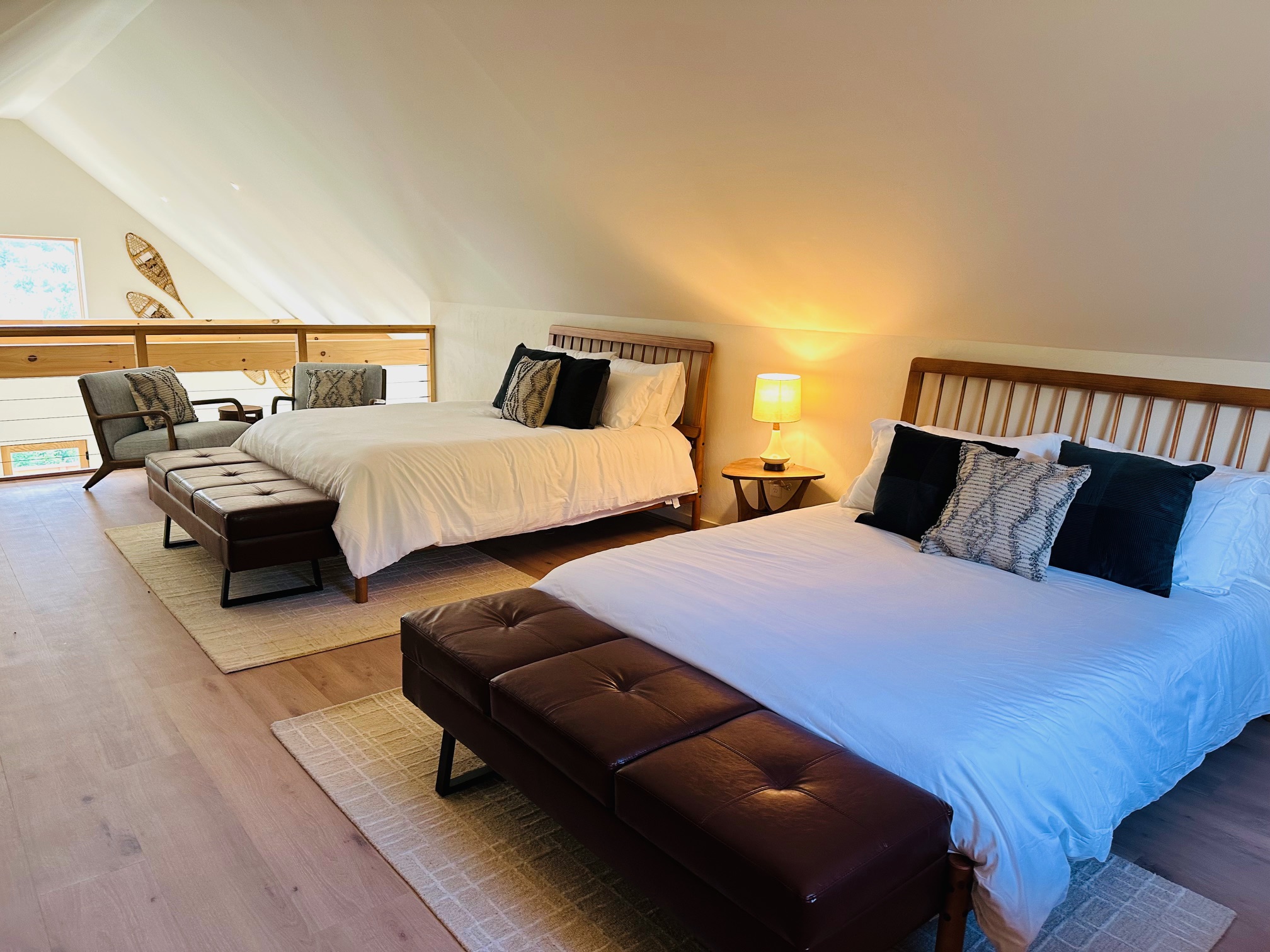 Loft sleeping area with two queen beds and sitting space
