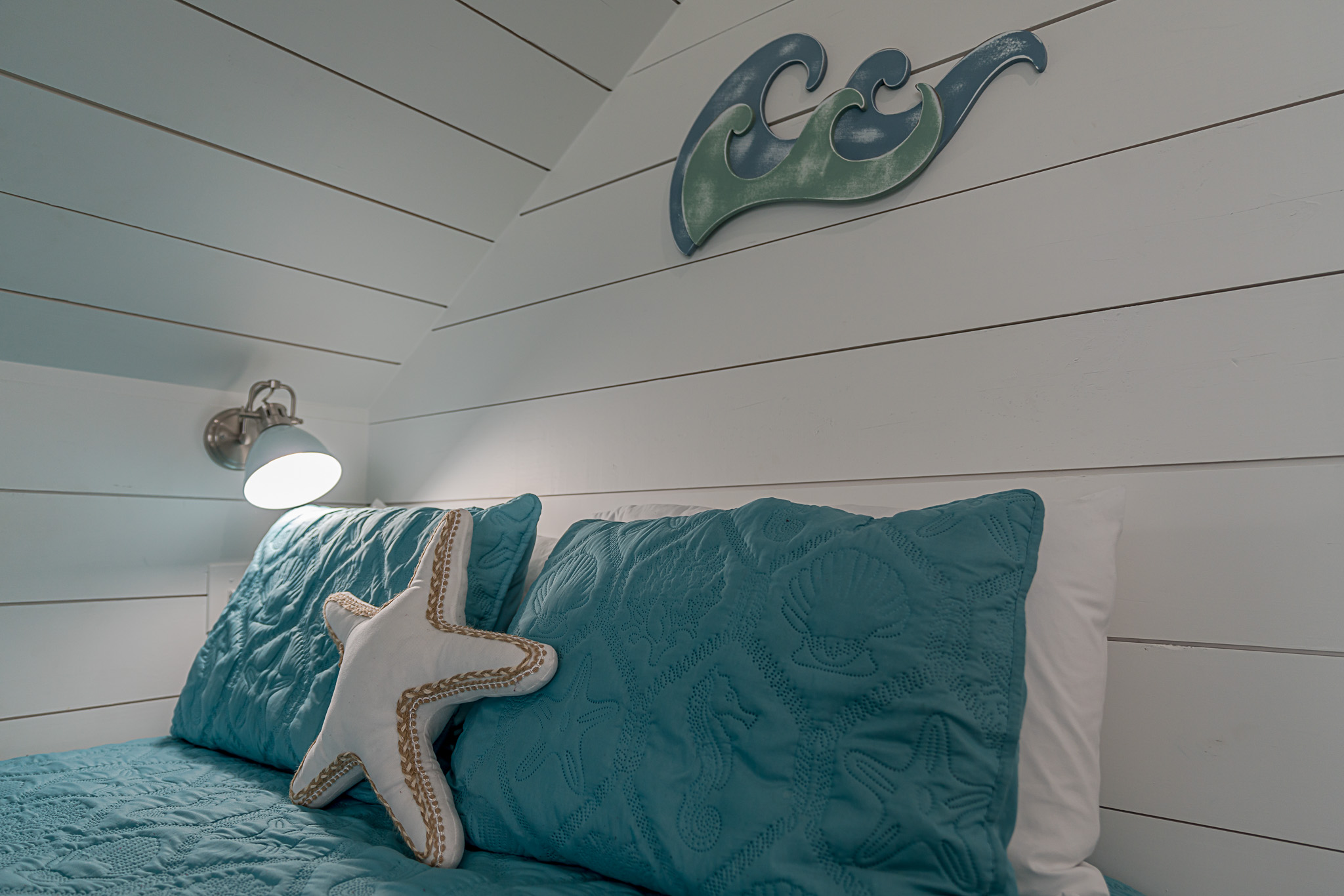 Reading lamps next to each of the beds in the bunk room.