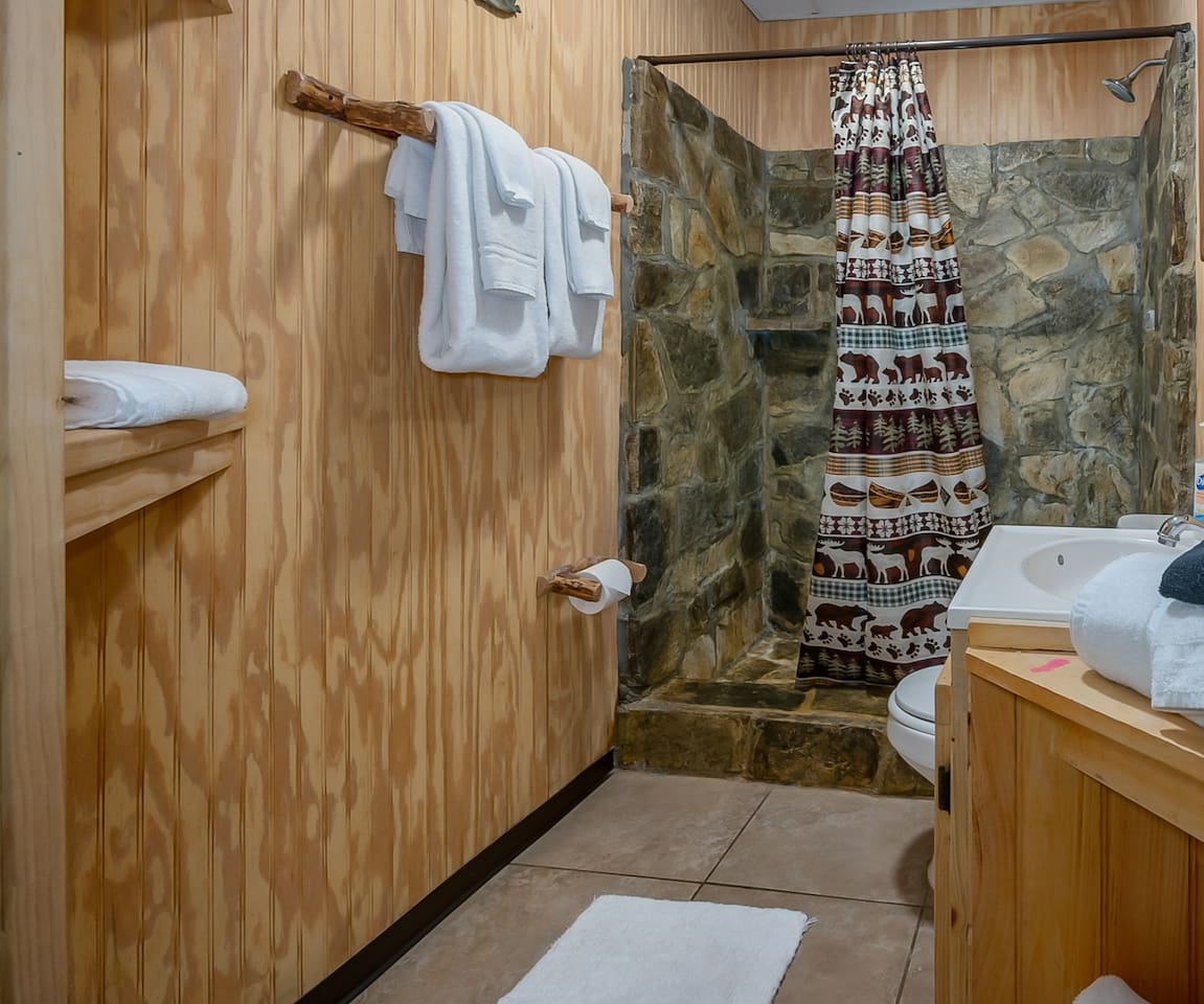 Lower level hand crafted stone spa shower.