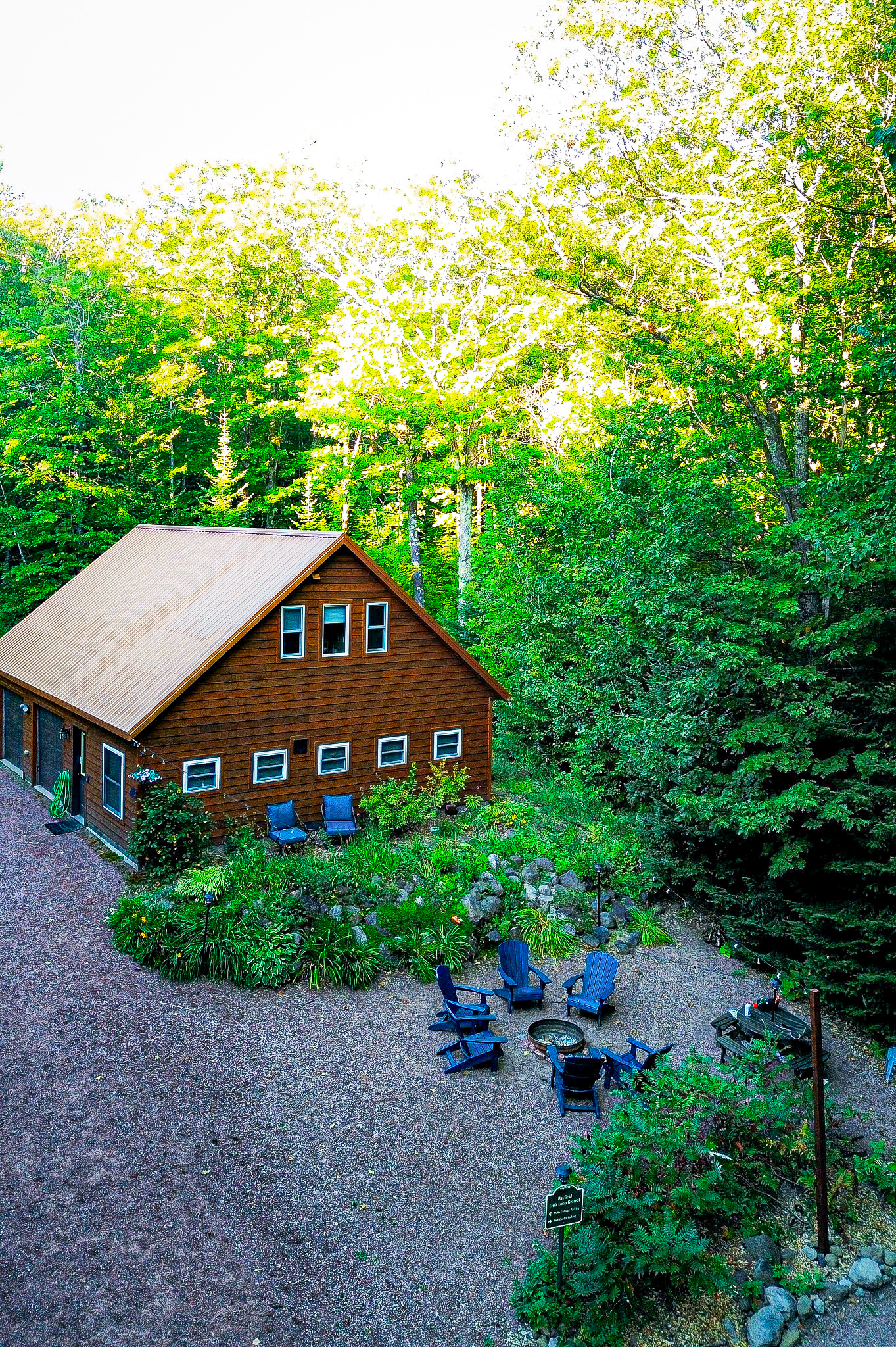 Rock Garden Cottage view from a drone high viewpoint feature fireplace and rock garden with perennial garden , many windows 