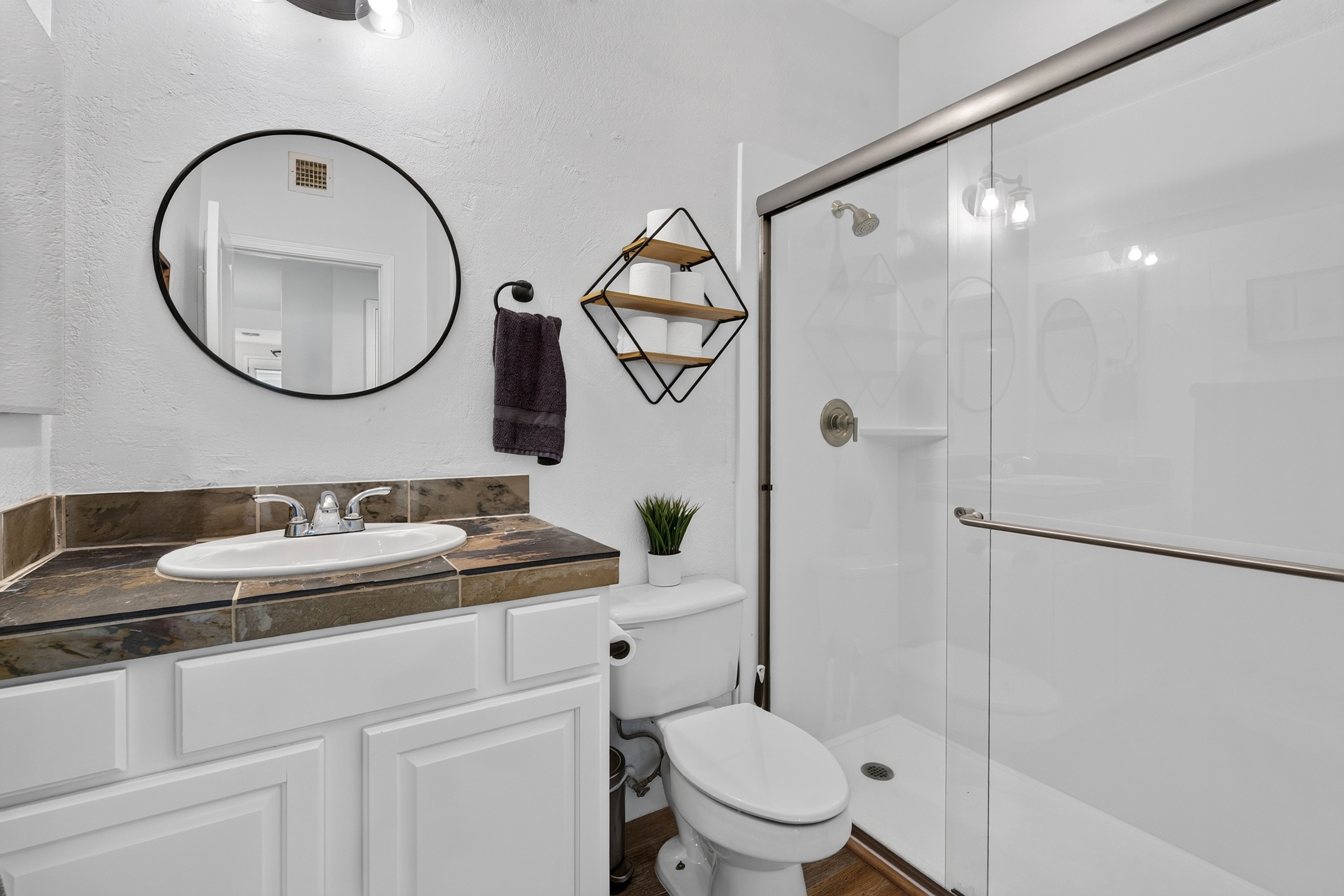 Bathroom with vanity storage, walk-in shower, soaking tub, and clean updated finishes for daily routines.