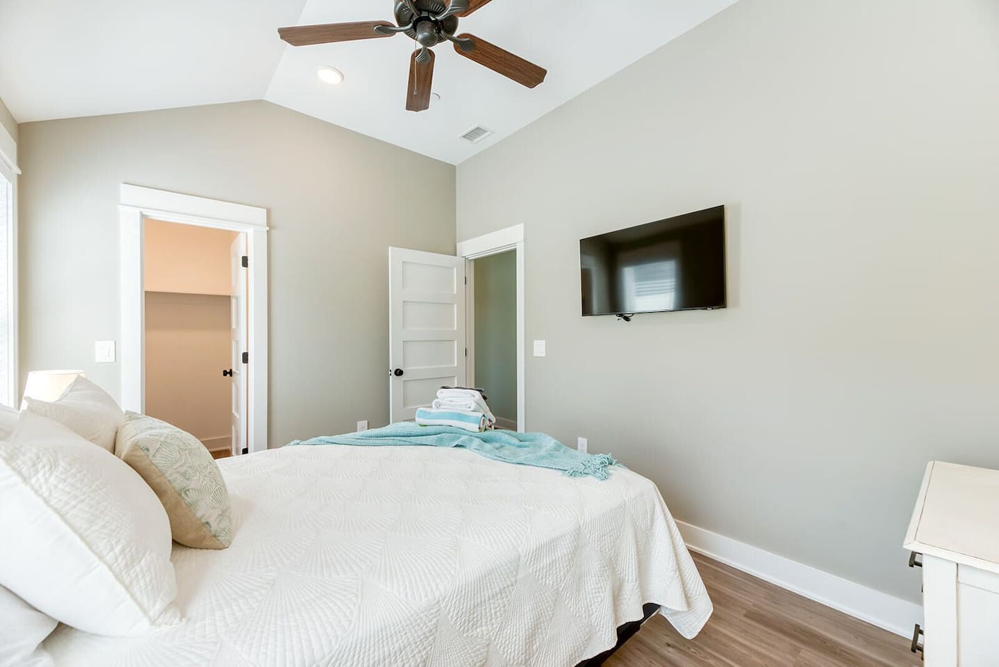 A cozy coastal bedroom with soft natural light and relaxing finishes.