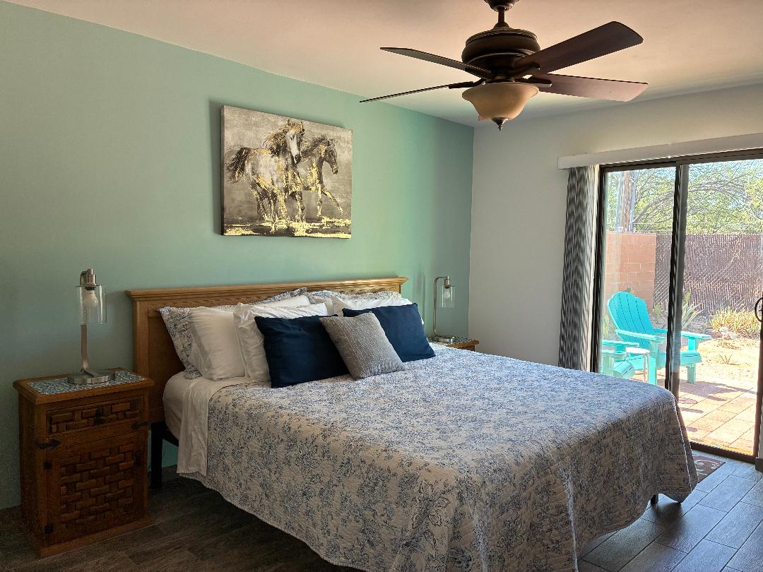 Bedroom, king bed, sliding door leads to walled and fenced backyard.