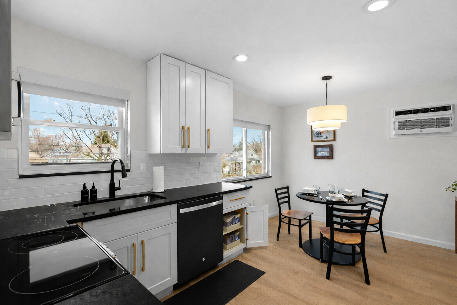 Cook and dine with ease in this modern kitchen featuring sleek finishes, ample counter space, and a sunny dining area perfect for everyday meals.