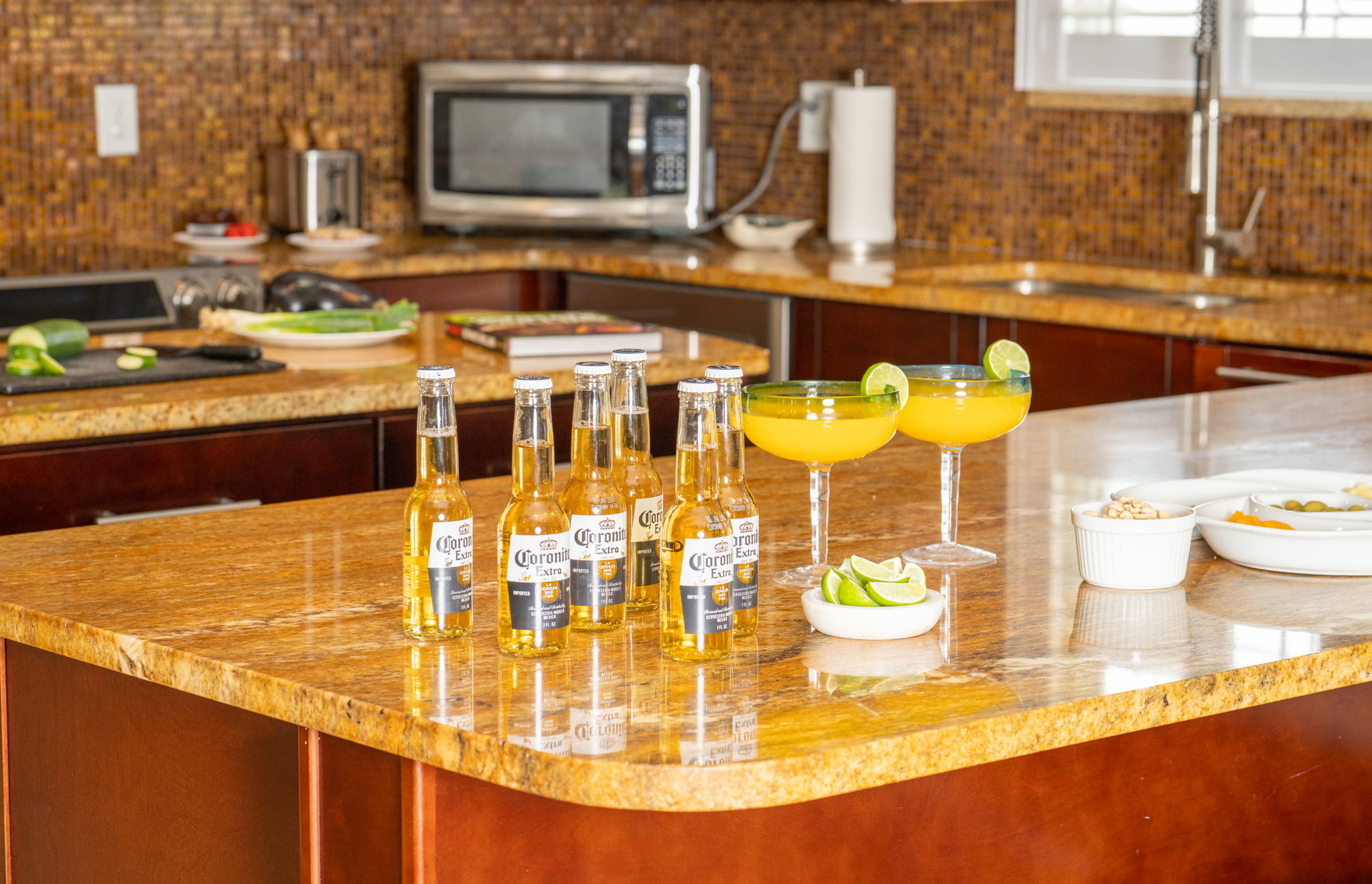 This kitchen features stainless steel appliances, pendant lighting, and an inviting center island perfect for meal prep or casual dining.