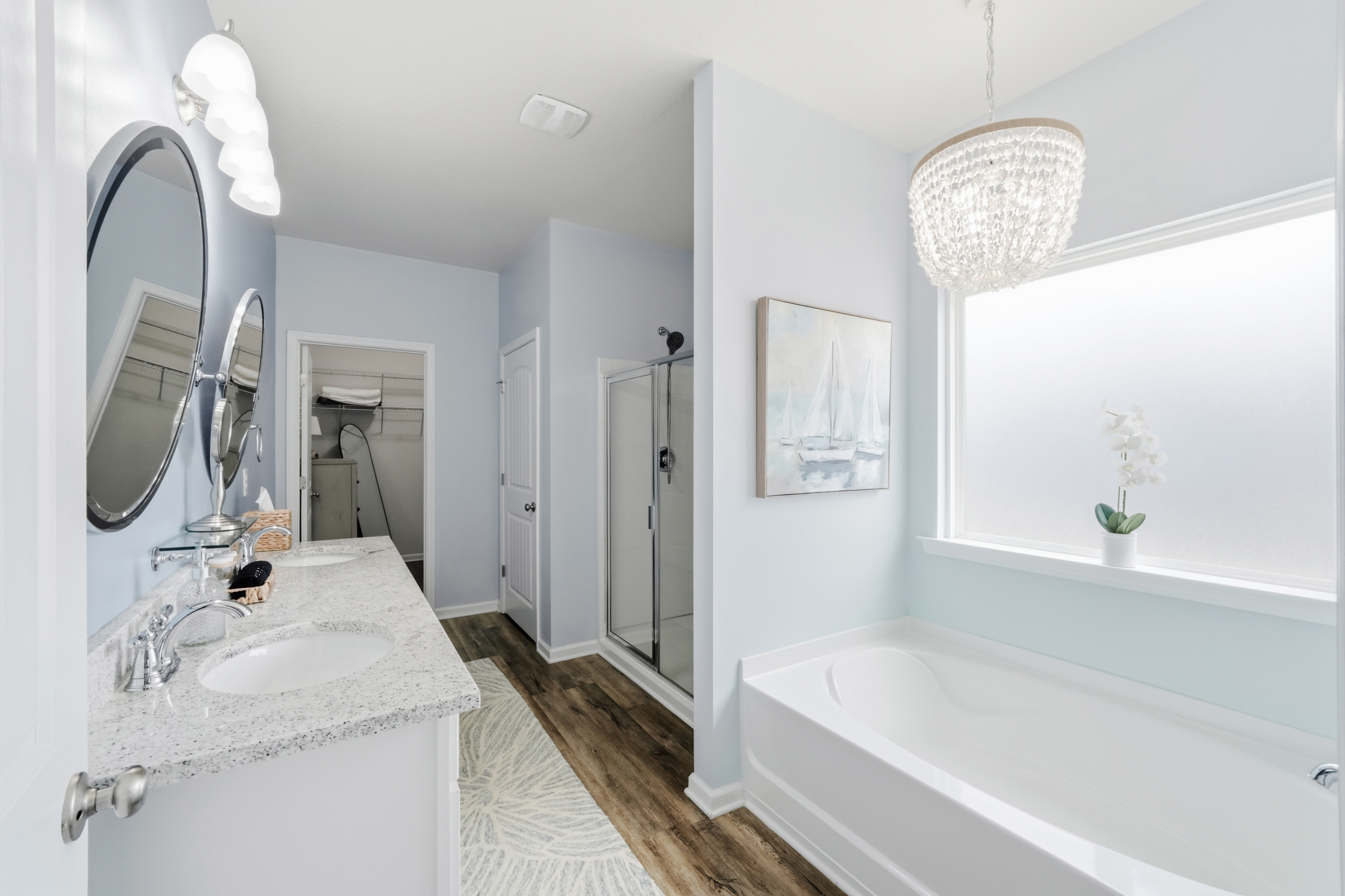 Primary Bathroom with double vanity with elegant finishes, Separate tub and walk-in shower for ultimate convenience