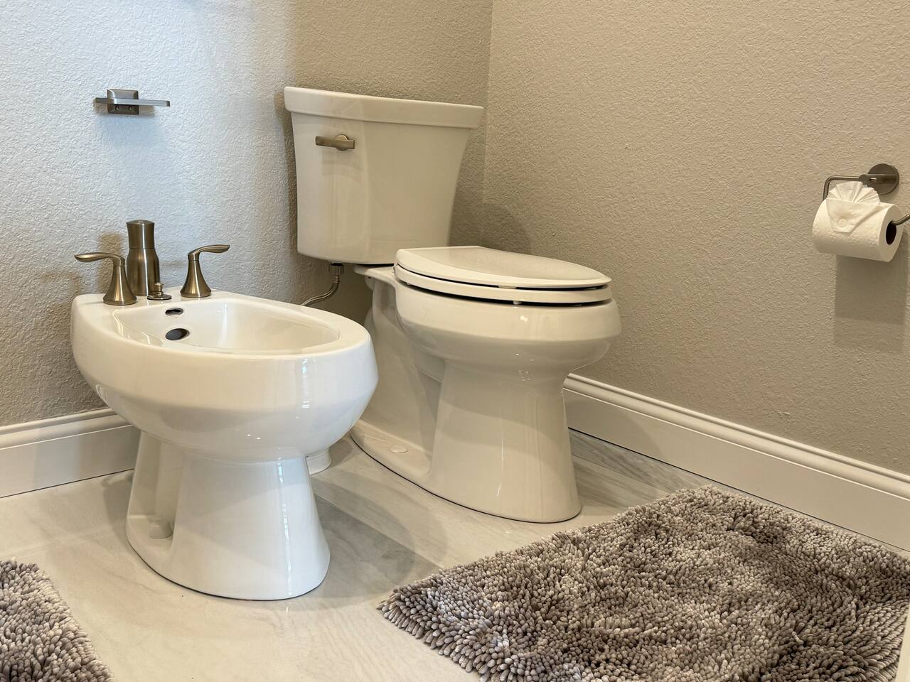 Master bathroom has both a bidet and a toilet. 