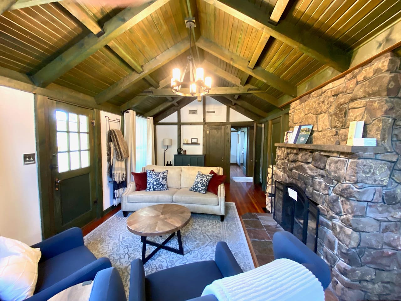 Living room with large stone fireplace.  This portion of the home is 100 years old and all original! 