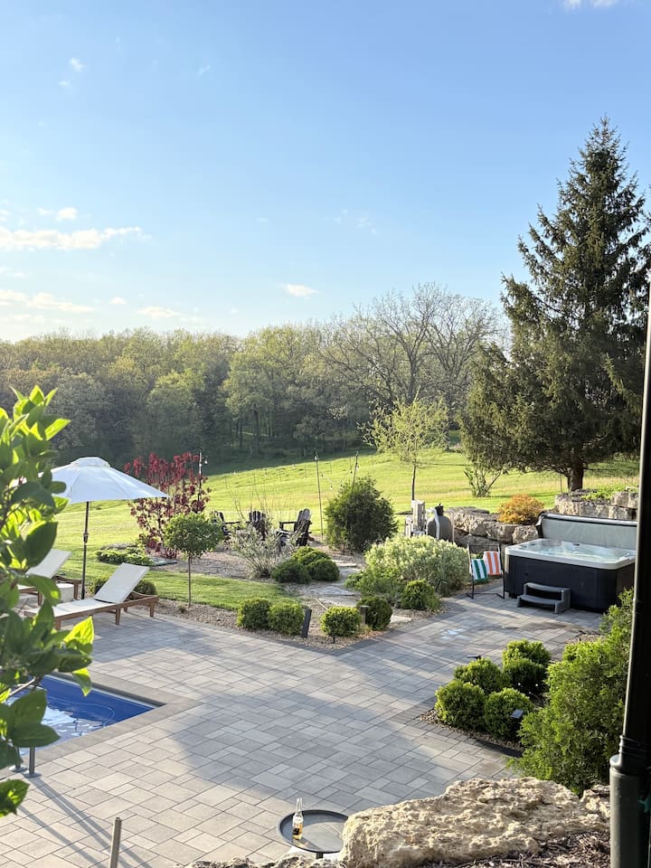 The gardens are a labor of love, and guests notice. Quiet hilltop in front, rolling Galena hills beyond.
