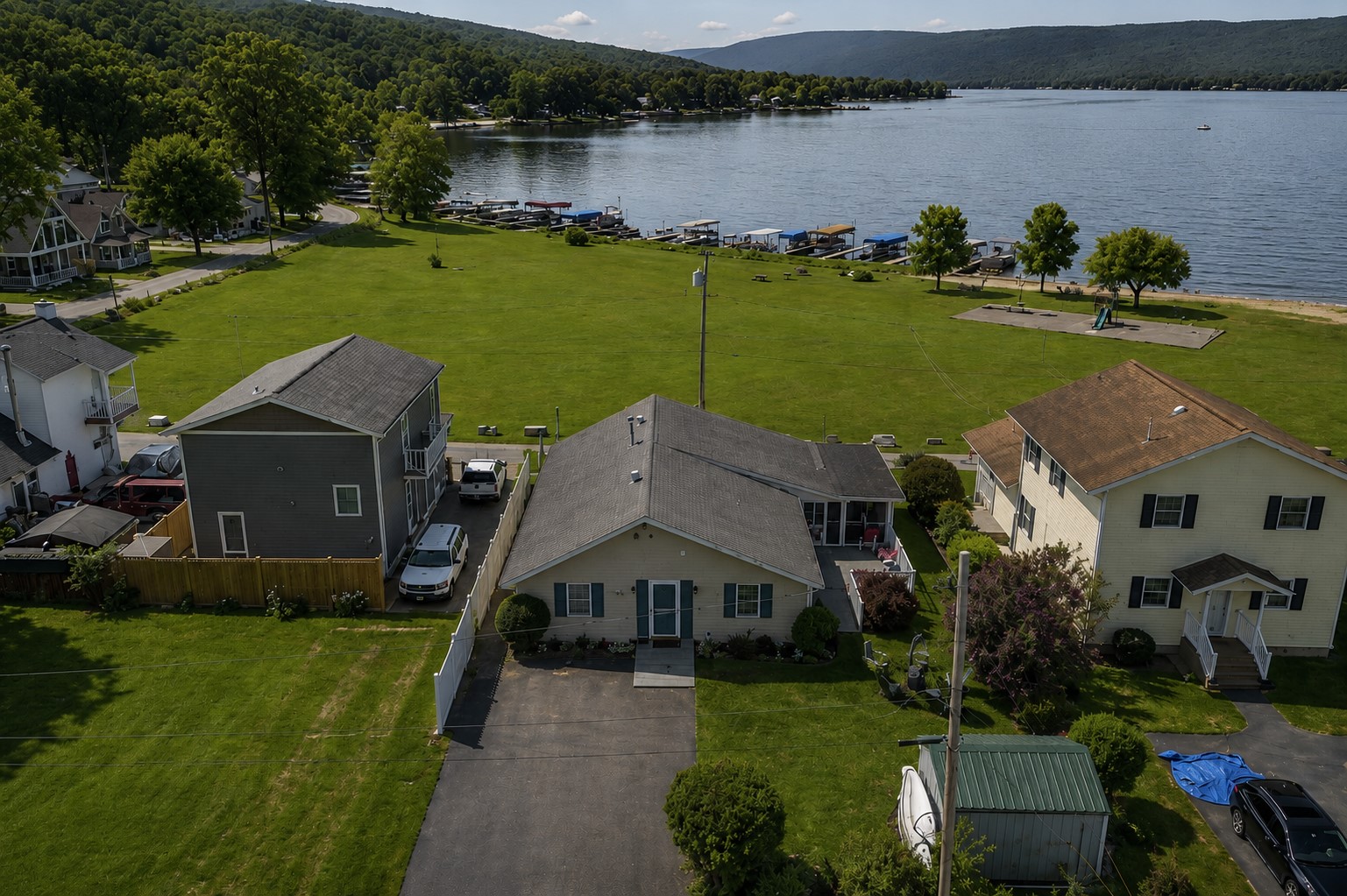 Charming lakeside retreat with ample green space and easy access to Honeoye Lake. Ideal for family gatherings and outdoor fun. 