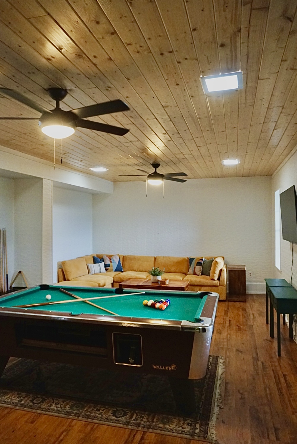 Enjoy billiards, plush seating, and a vibrant wooden ceiling for endless fun!