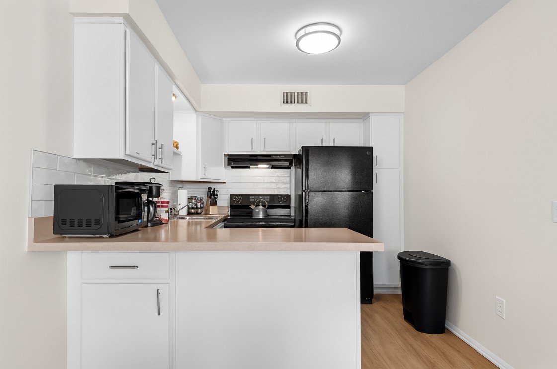 Sleek kitchen with modern appliances, ample counter space, and fully stocked essentials—perfect for cooking meals and enjoying a comfortable stay.
