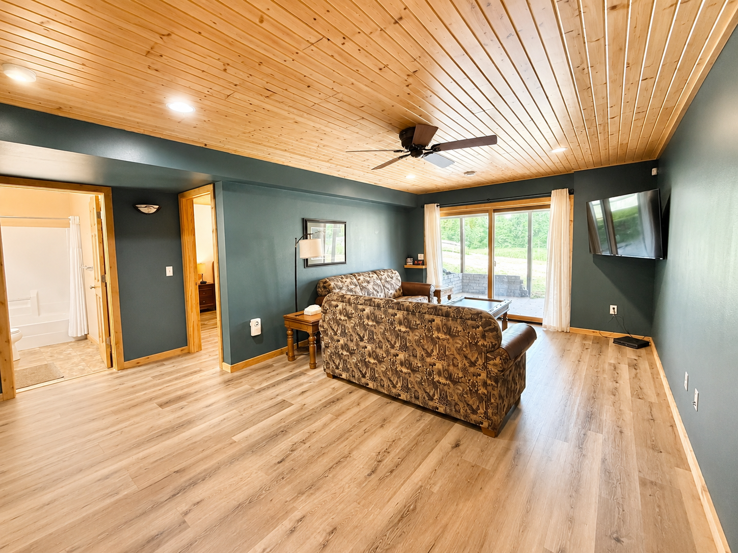 Lower level living area with a large TV and comfortable seating gives your group another place to relax and spread out.
