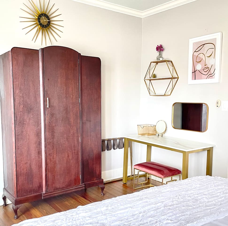 Antique armoire and modern vanity.