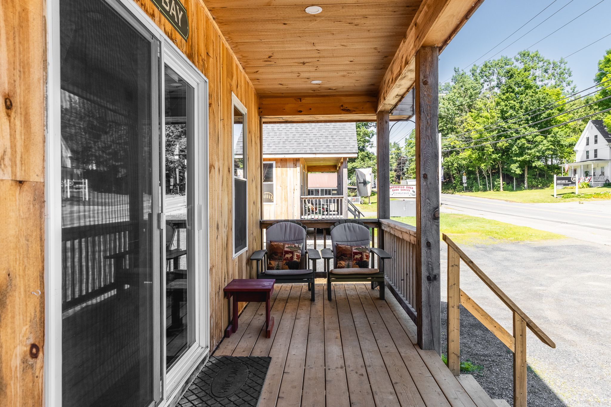 Front porch with Adirondack chairs to relax with access to restaurants and shops