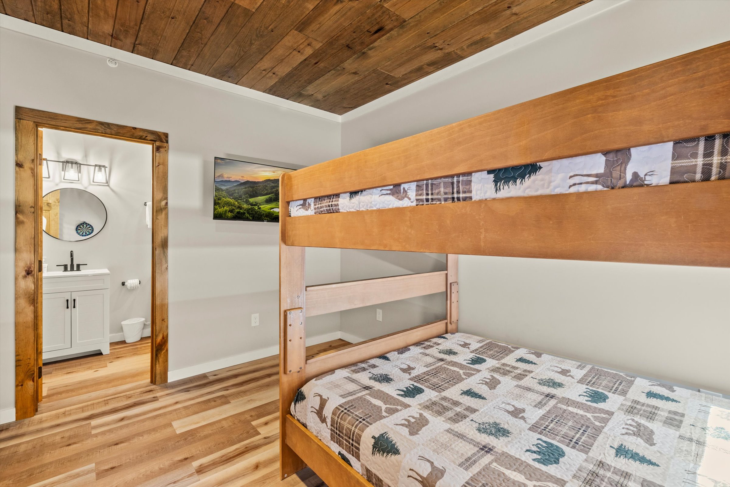 The bedroom has a large Smart TV and an attached full bathroom.