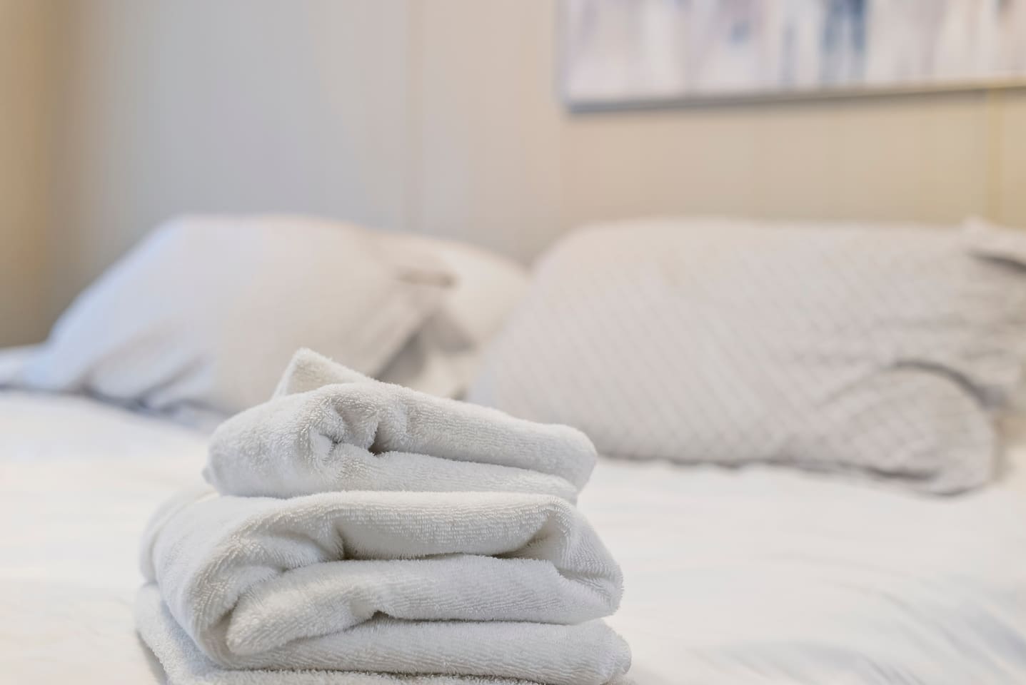 Stack of fresh, fluffy towels, prepared to make your stay even more comfortable.