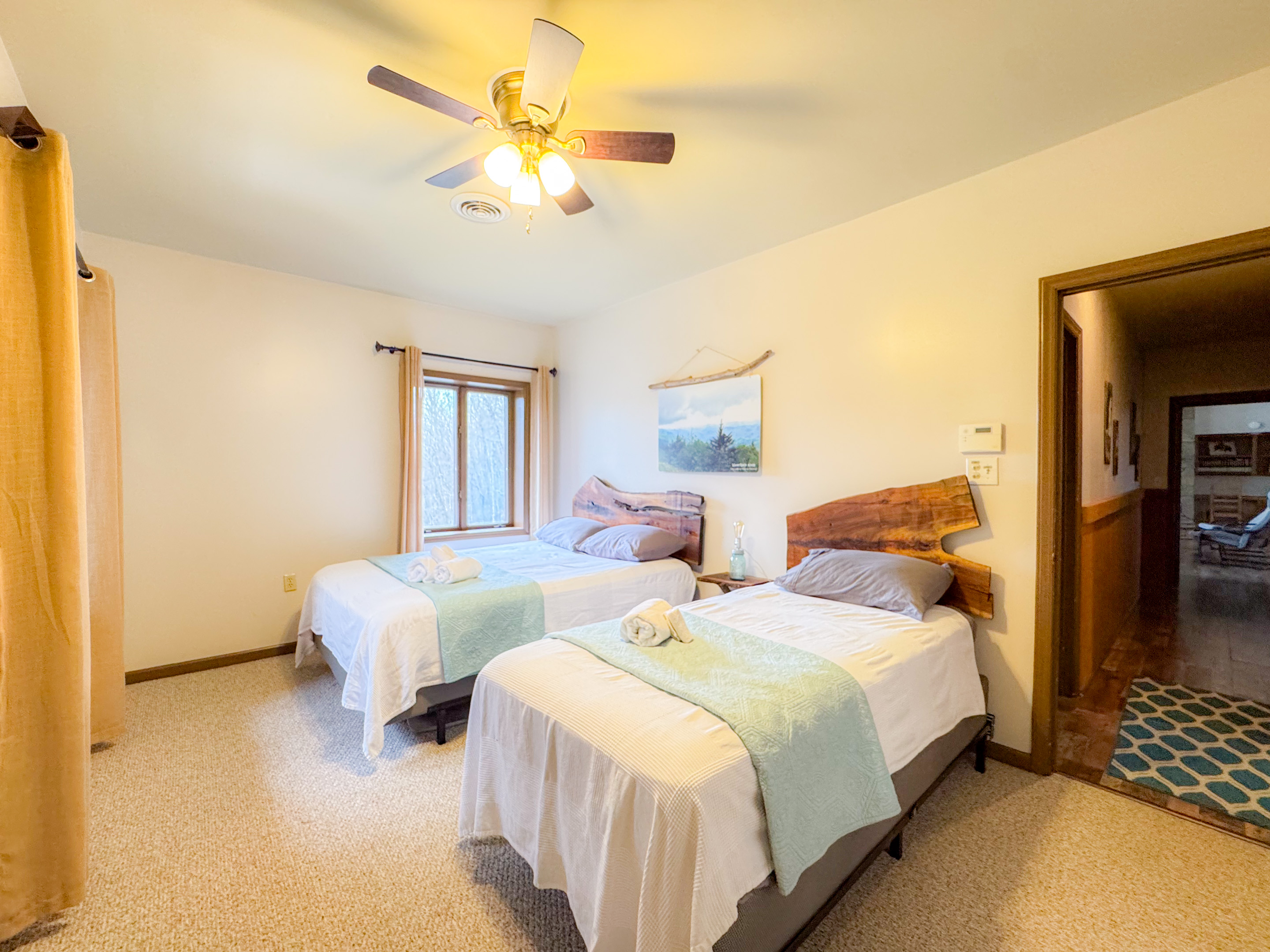 our Waterrock Knob themed bedroom features a queen and twin bed on the upper level. The bedroom overlooks Waterrock Knob in the distance.