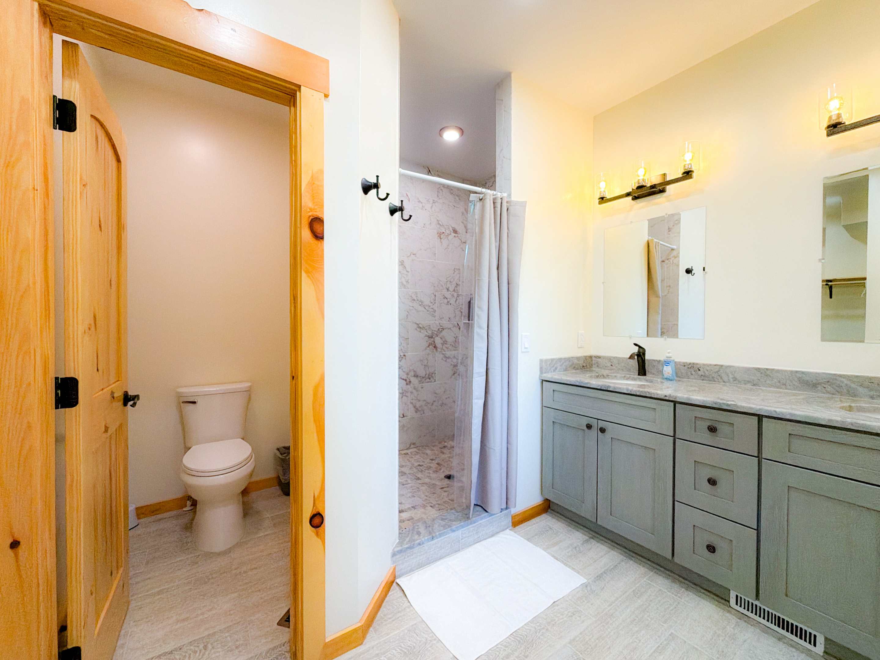 The Master Bathroom features double vanity sinks, large tile shower, and a separate space for the toilet.
