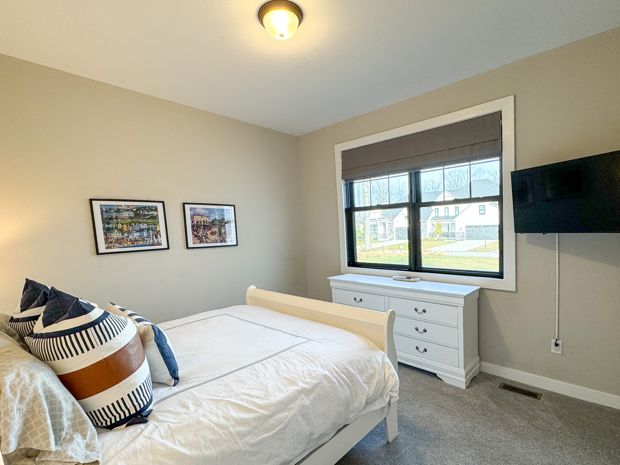 Guest bedroom with queen bed and tv with streaming.