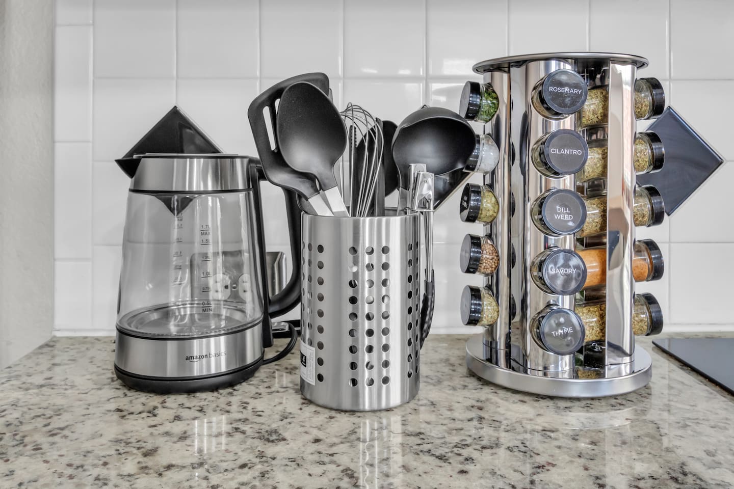 Guest-ready kitchen setup featuring a kettle, spices, and everyday cooking utensils, ideal for short and extended stays.
