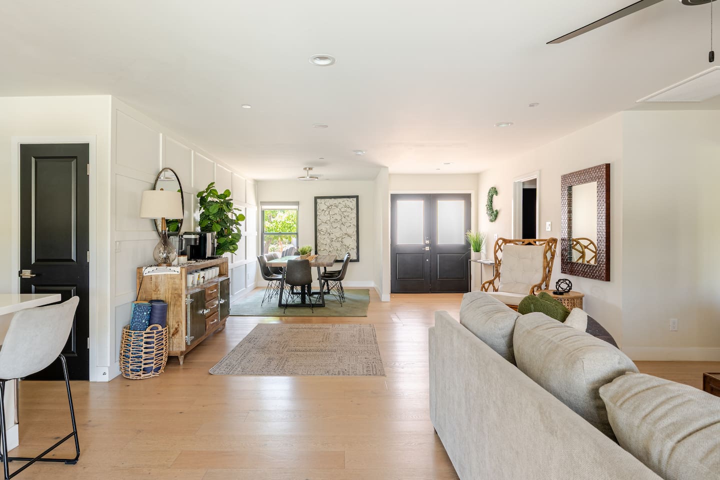 Natural light fills this warm entryway and stylish dining space. The open flow leads effortlessly from the front door through to the heart of the home.