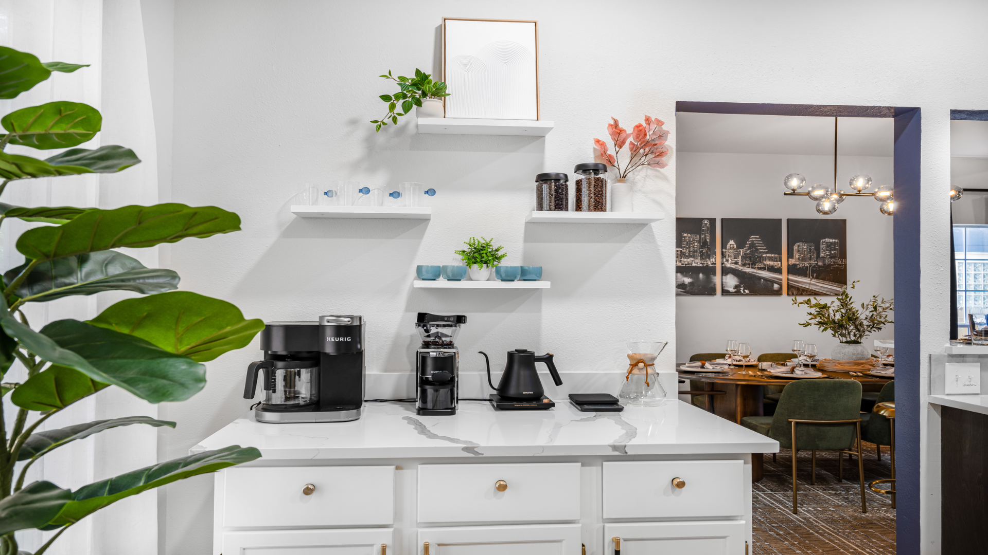Kickstart your day at this stylish coffee & tea bar! With sleek white cabinets, quartz countertops, & open shelves, it's perfect for brewing your favorite cup. Whether you're into coffee or te
