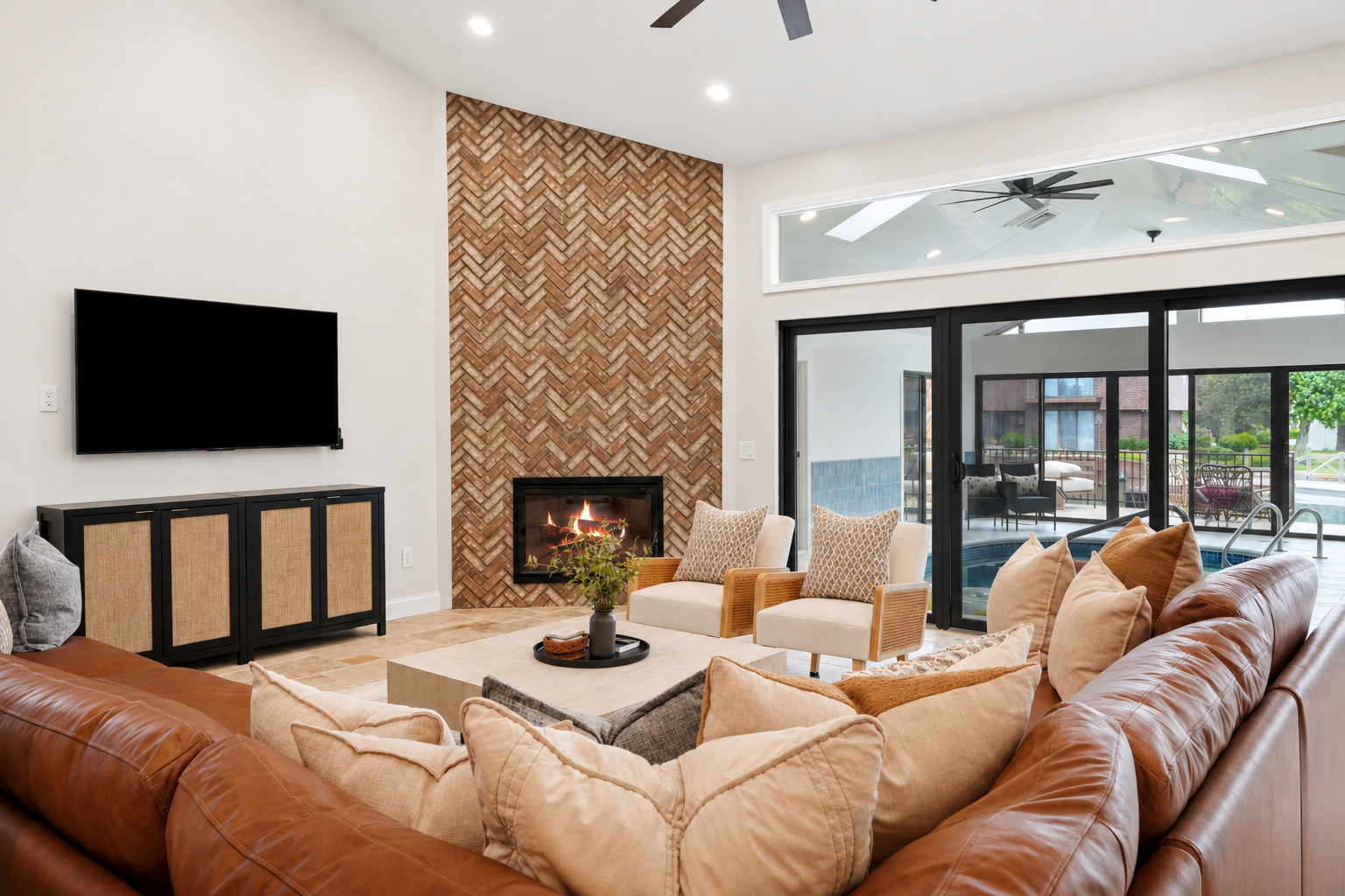 Spacious living room with a cozy sectional, modern fireplace, and open-concept layout. Bright, stylish space perfect for relaxing and gathering.