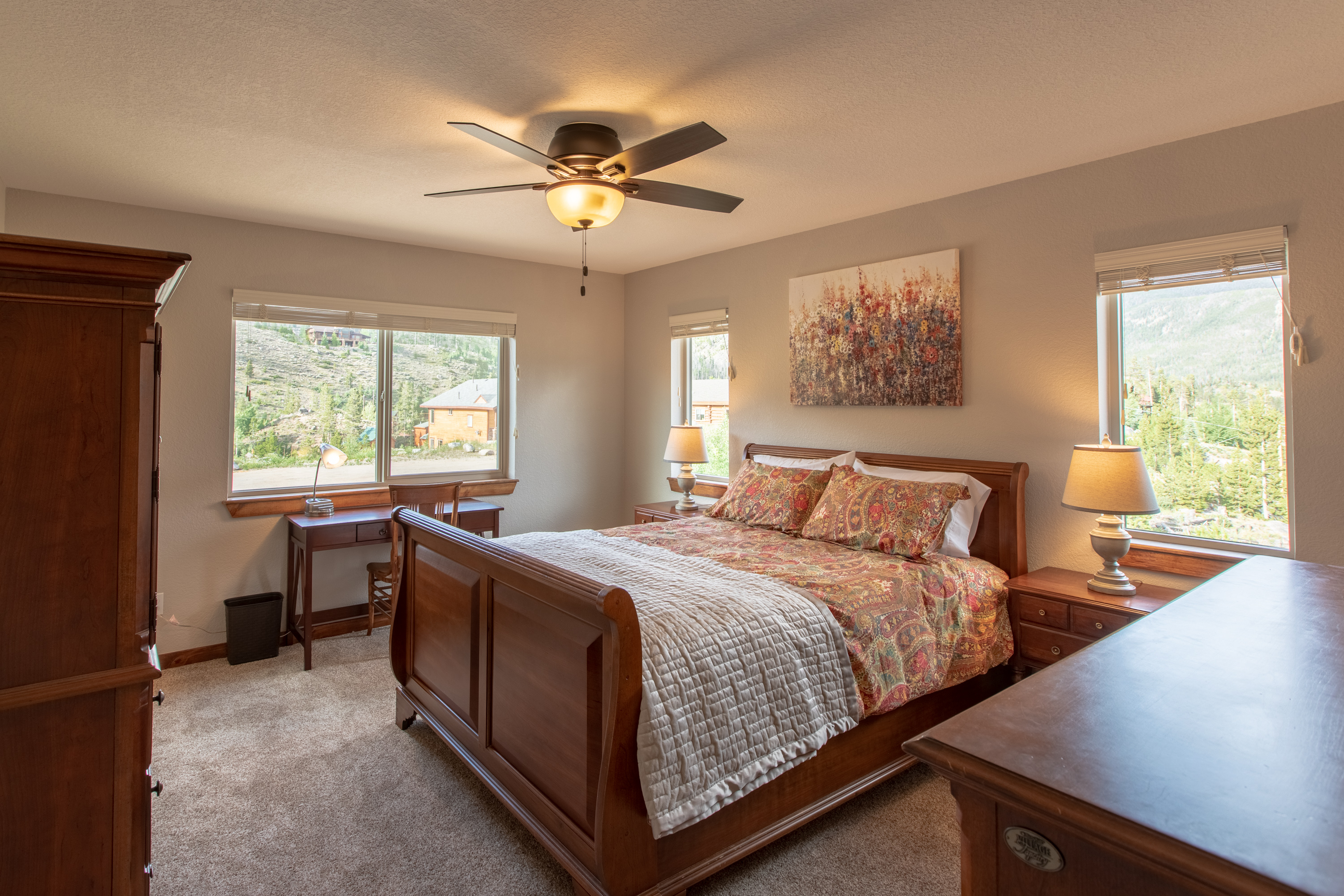 Upstairs Bedroom 3 Spacious queen bedroom featuring a dedicated work desk, ample storage, and elegant high-end furnishings—perfect for both relaxation and productivity during your stay!