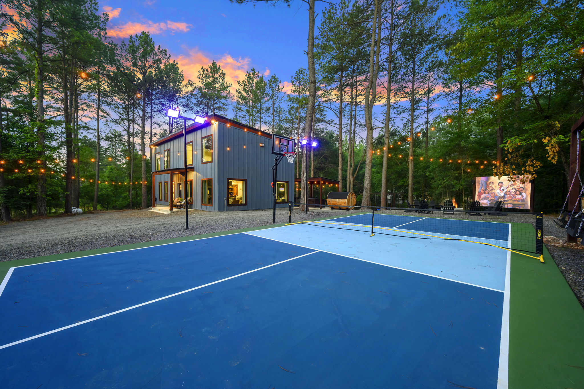 Play doesn’t stop when the sun goes down. Private pickleball + basketball court under the pines, lit for evening games, with spectator swings, fire pit & outdoor cinema just steps away.
