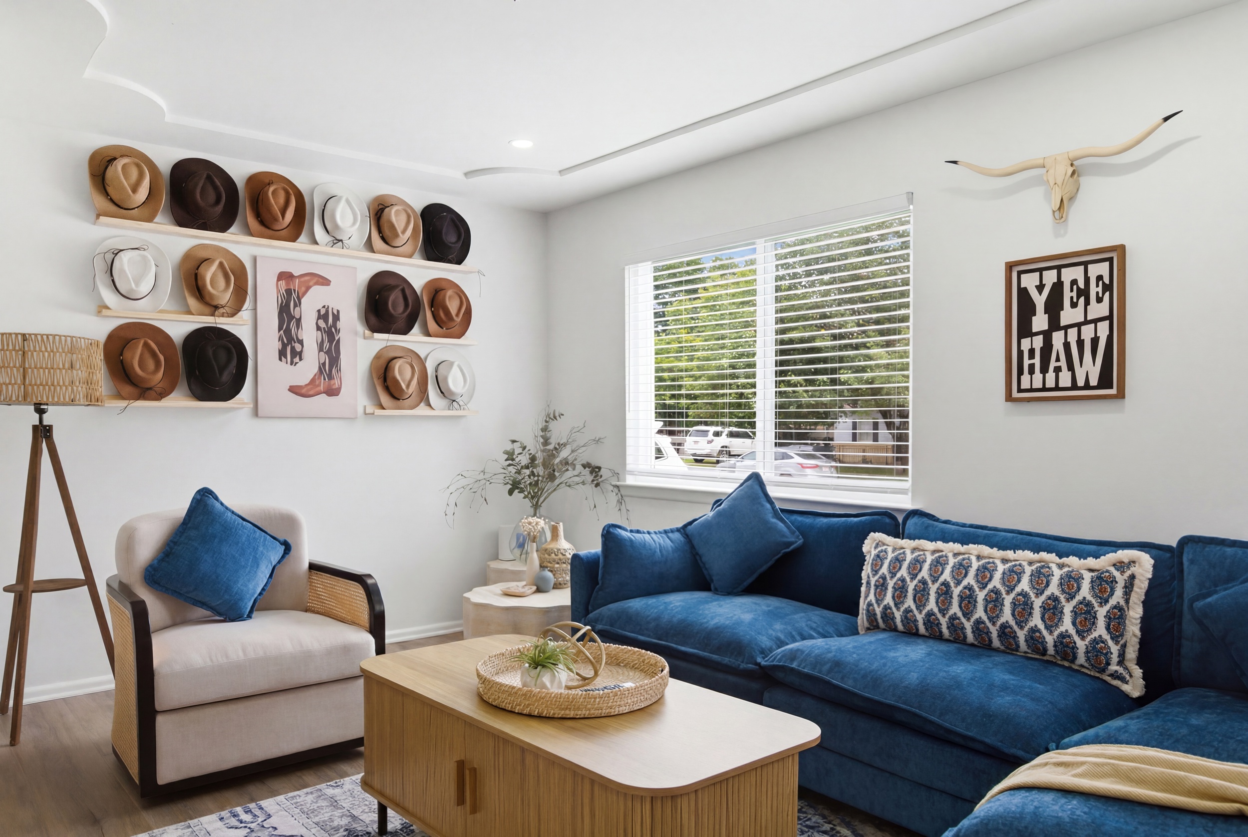 Texas-themed Living Room with cowboy hat gallery wall, plush blue seating, and bright natural light. Perfect for relaxing after a Cowboys game at AT&T Stadium.
