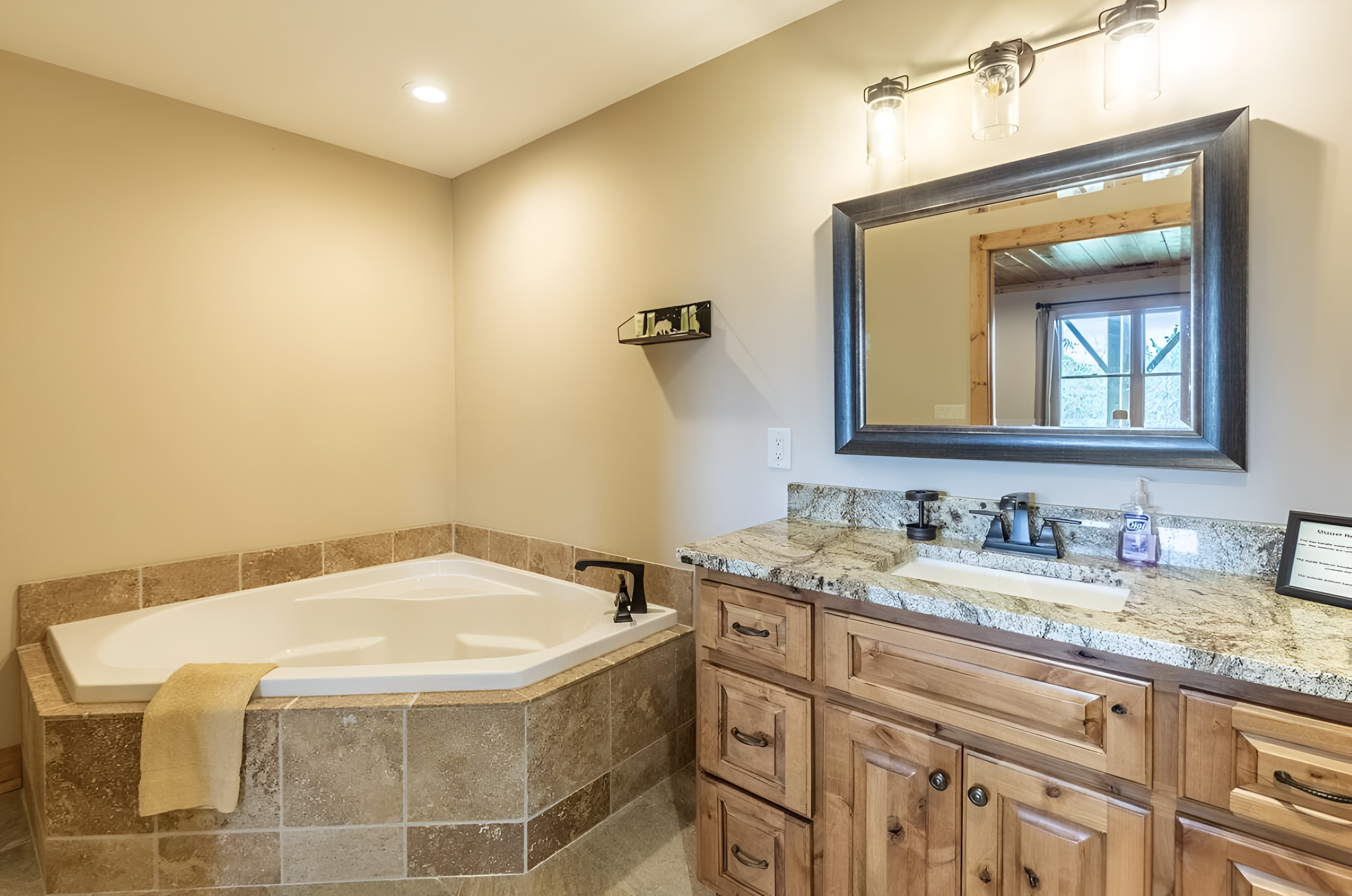 The upper level king bathroom has a large tub and sink for your stay.