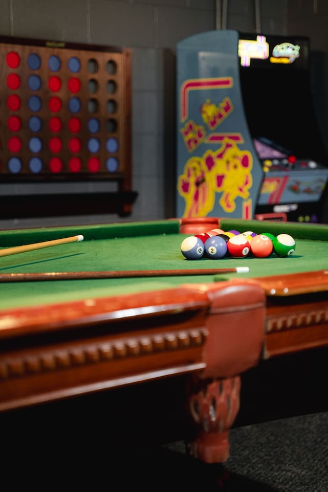 Arcade games and pool tables - fun for everyone in the game room at Timber Twine.