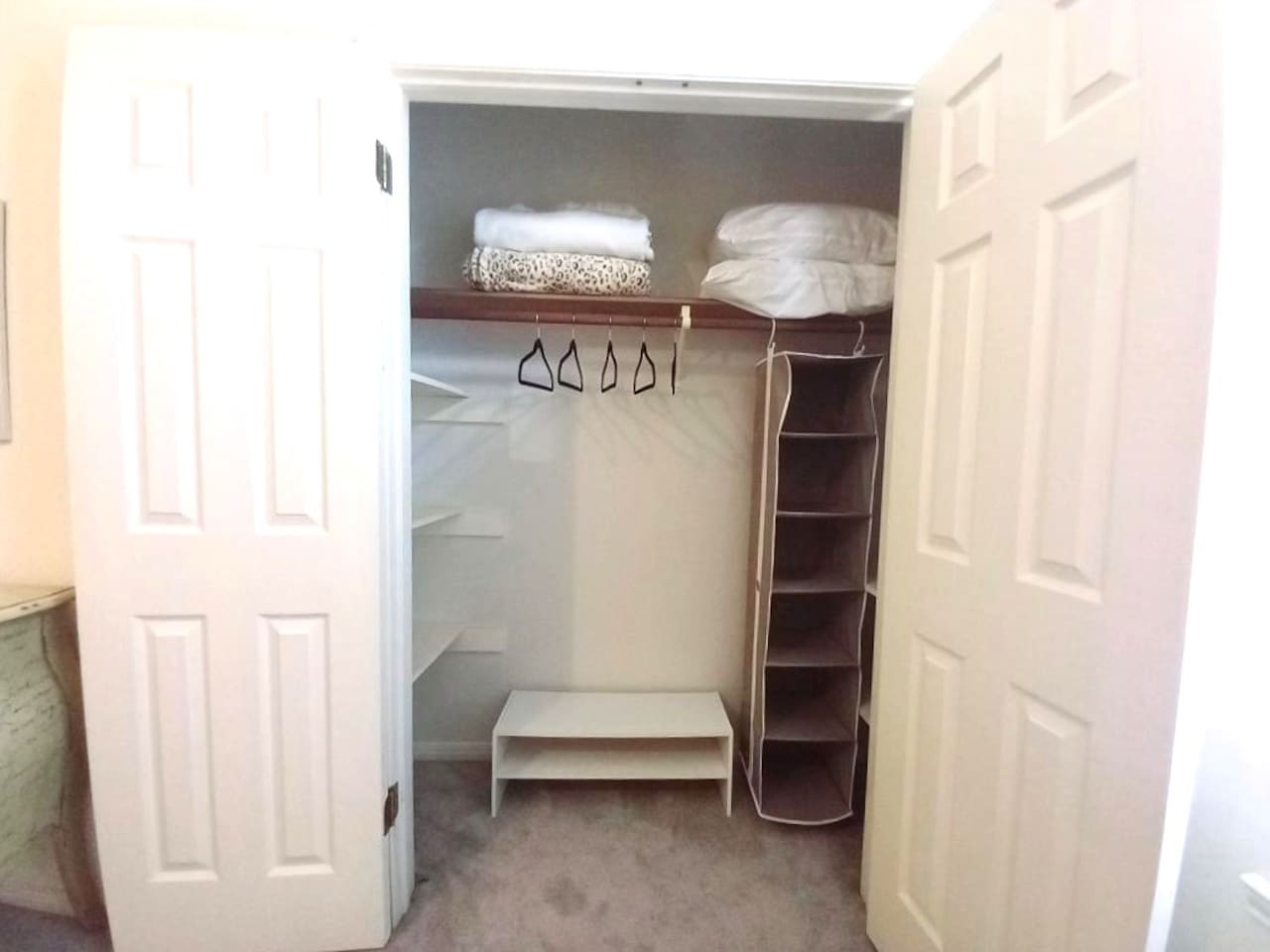 Generous closet space throughout the house.  This closet in Angel's Keep features hanging space, shoe rack and shelving on both sides of the closet.   Great whether staying for a weekend or a month or more.