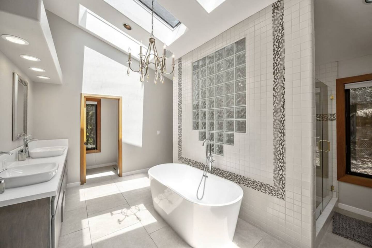 Ensuite bathroom attached to the primary bedroom. Soaking tub, two sinks, large shower with two shower heads, and two walk-in closets.