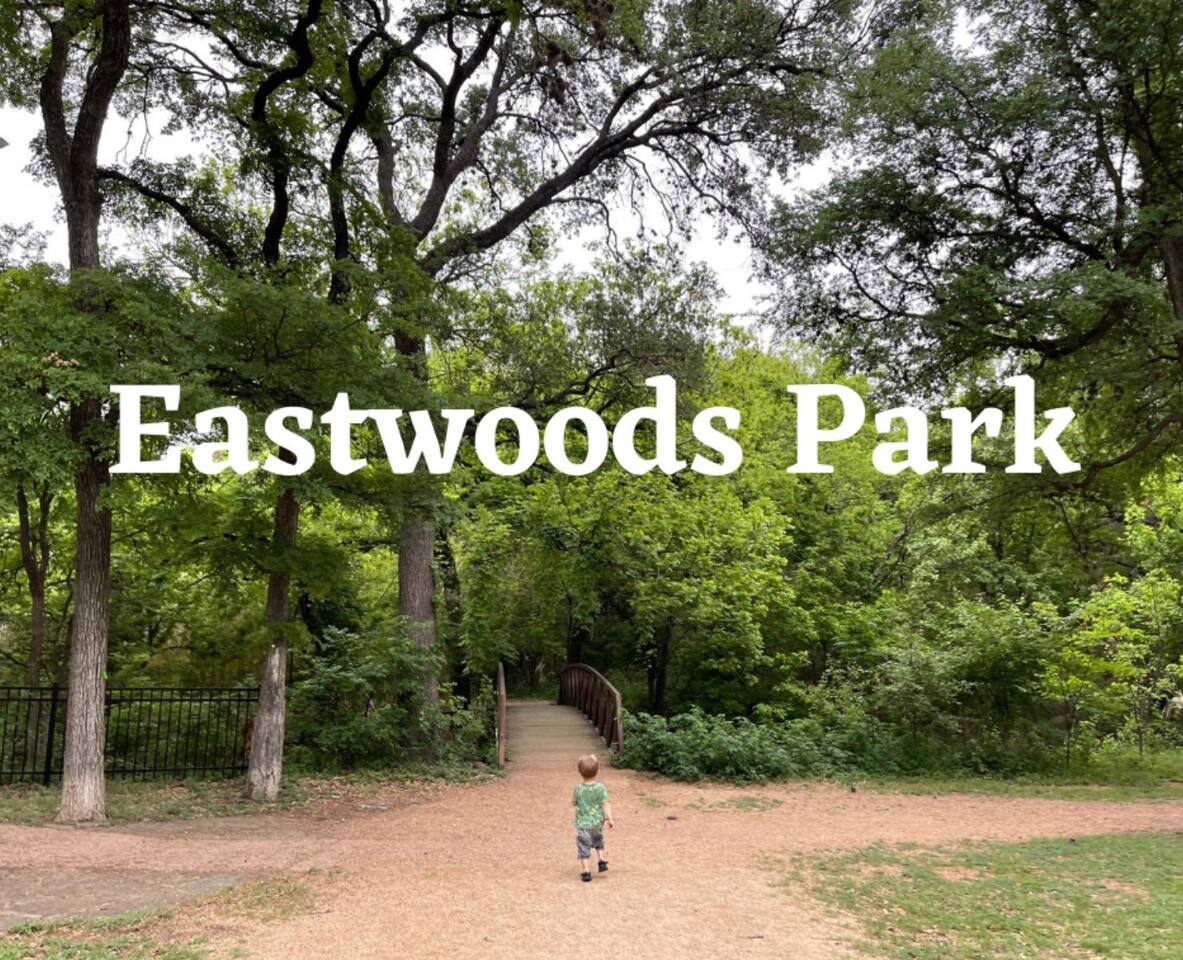 backyard is  eastwood park where there is a playground, tennis court, water splash pad.