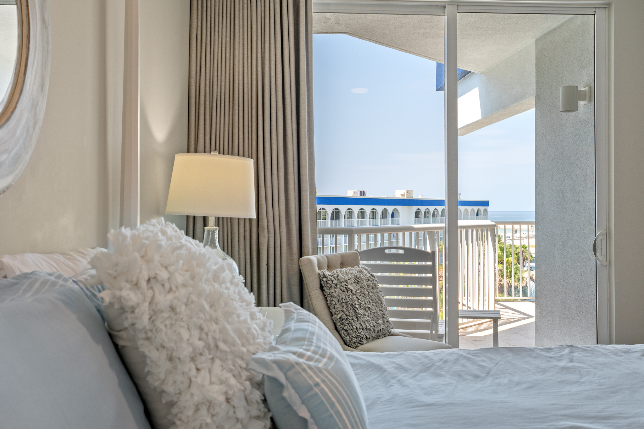 Bedroom w/ large windows and balcony access for a light, airy feel.